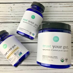 Three bottles of vegan probiotic supplements.