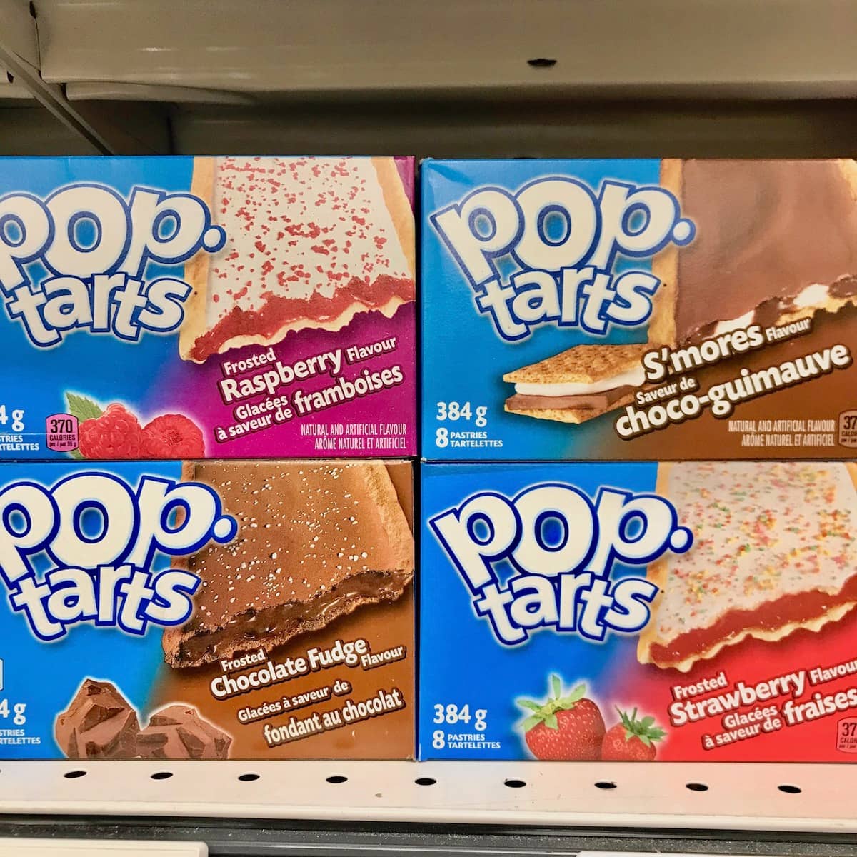 Four boxes of Pop-Tarts on a shelf.