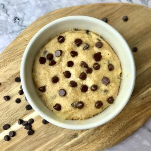 A banana chocolate chips mug cake in a white ramekin.