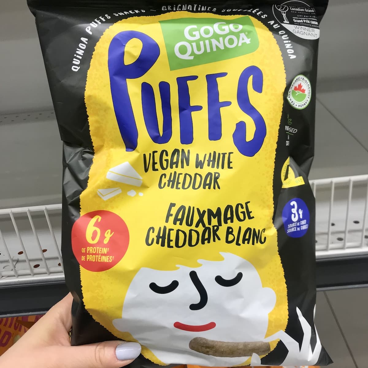 A bag of GoGo Quinoa Vegan White Cheddar Puffs.