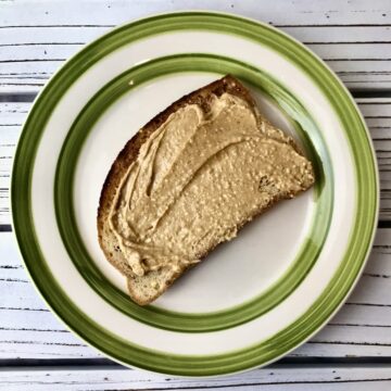 A slice of toast with peanut butter on it.