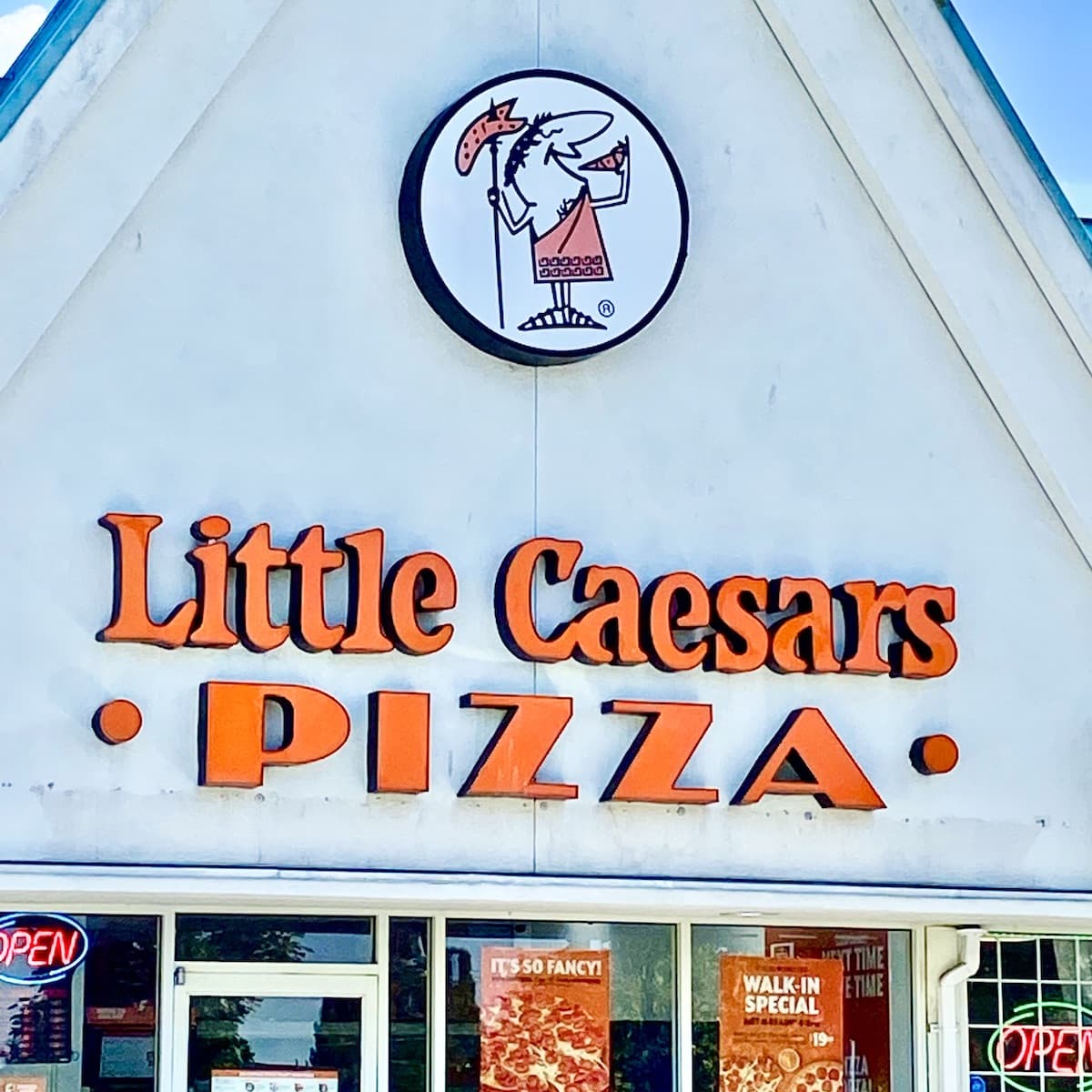 A Little Caesars Pizza sign on a building.