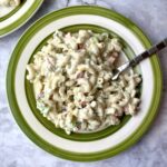 A plate of creamy vegan macaroni with a fork in it.