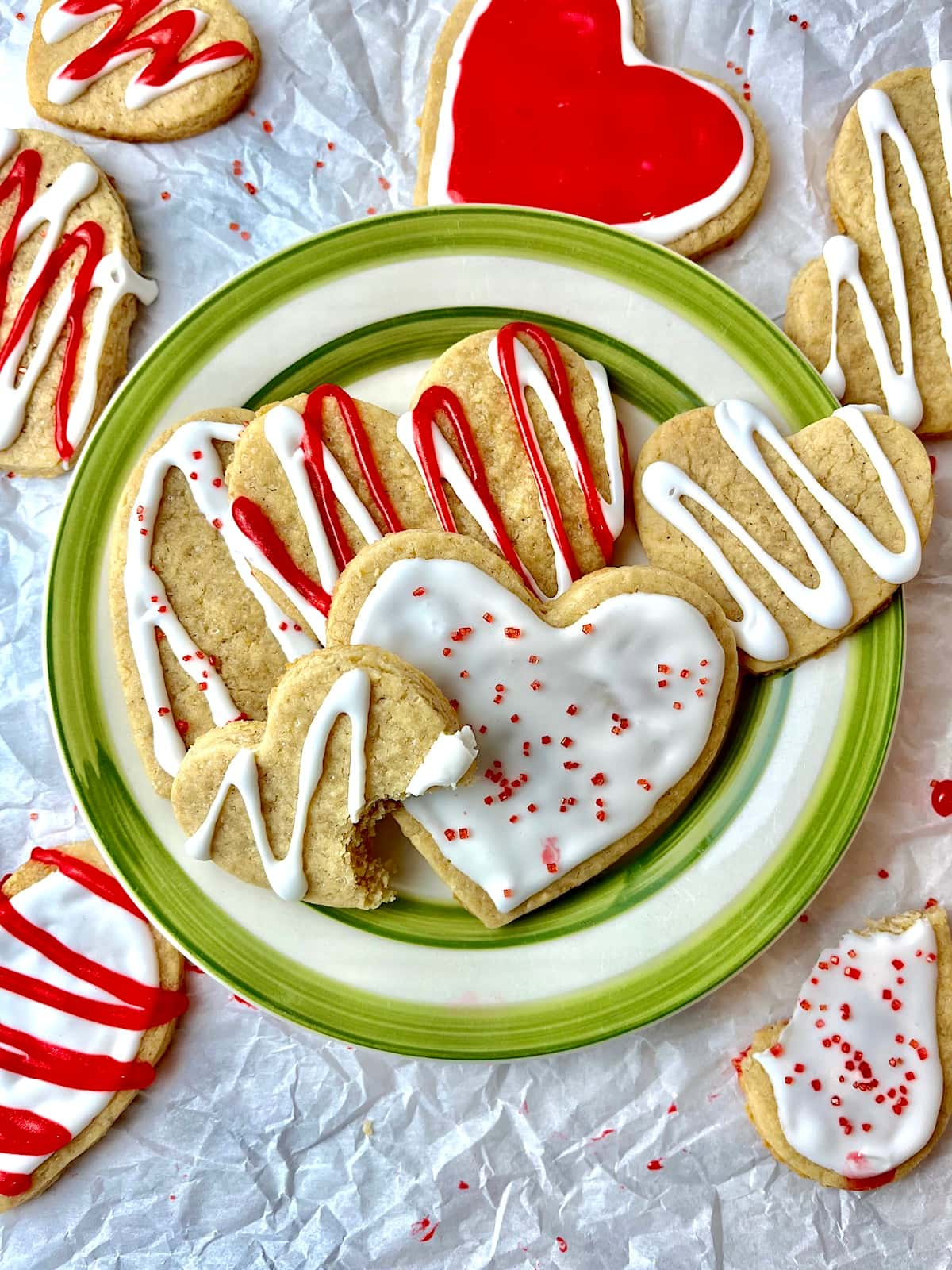 A plate of Valentine's Day sugar cookies decorated with red and white icing.