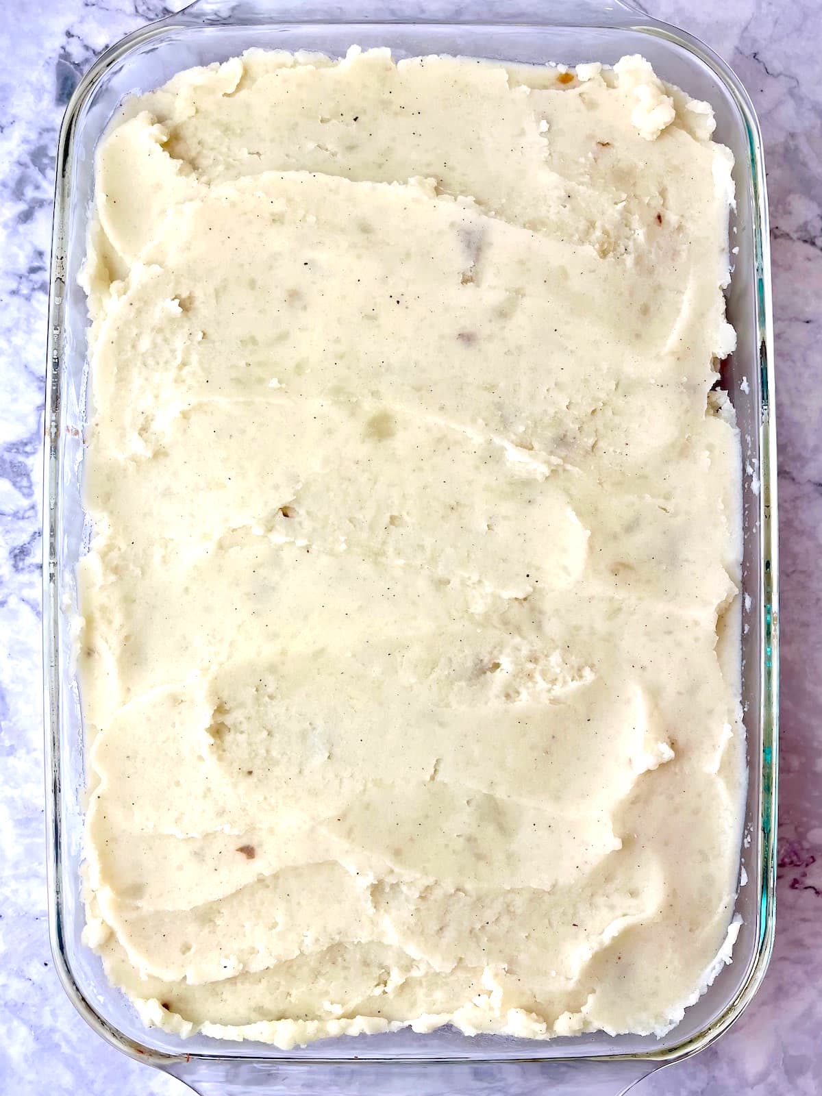 A large baking dish of vegan lentil shepherd's pie.