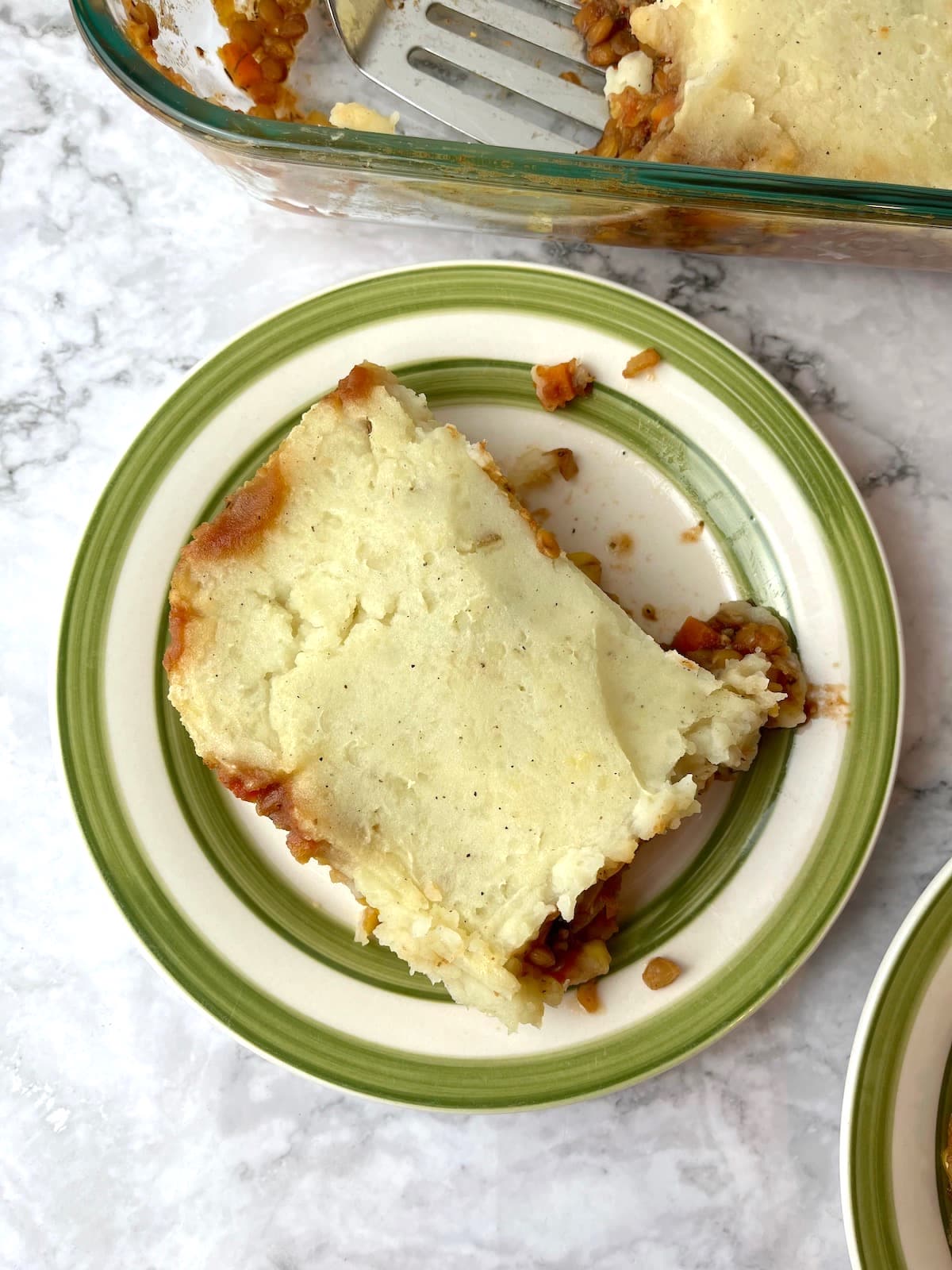 A piece of vegan lentil shepherd's pie on a plate.