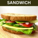 A veggie sandwich with text that says Veggie Pesto Sandwich.