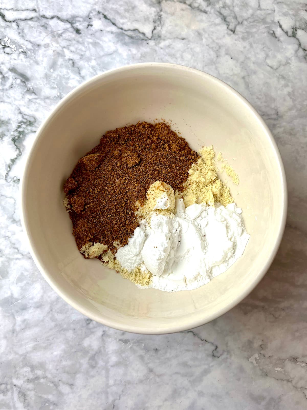 Cinnamon mug cake ingredients in a bowl.