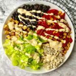 A high protein vegan bowl topped with a creamy dressing.