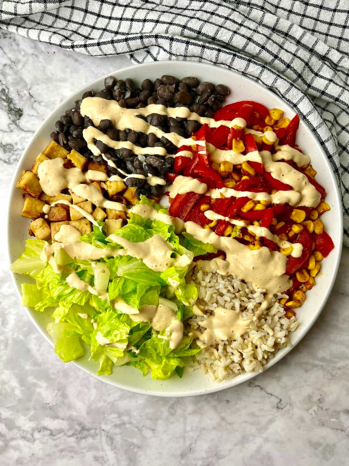 A high protein vegan bowl topped with a creamy dressing.