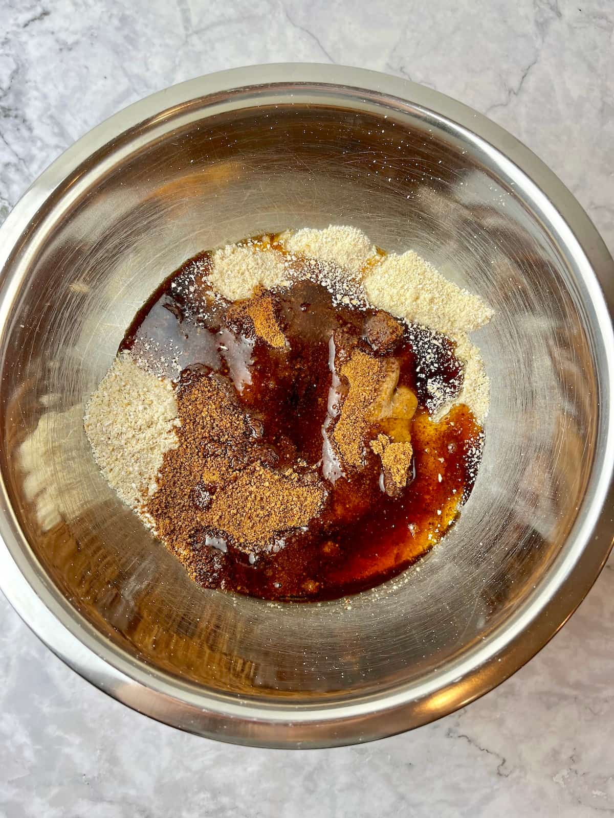Vegan almond butter cookie ingredients in a mixing bowl.