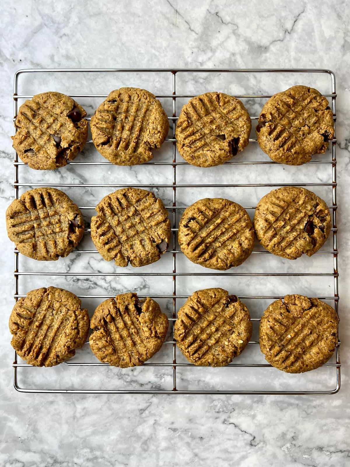 Vegan almond butter chocolate chip cookies on a cooling rack.