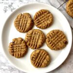 Vegan almond butter cookies on a white plate.